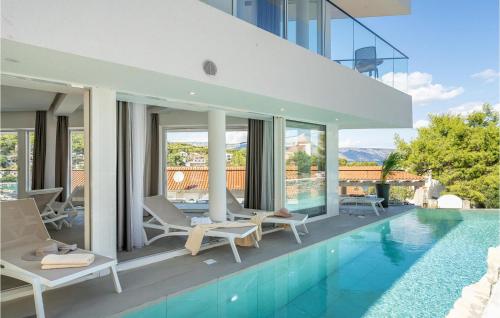 a villa with a swimming pool and a house at Villa Aestas in Vrboska