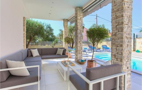 a living room with a couch and a table and a pool at Villa Valentino in Kornić