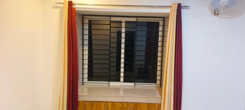 a mirror in a room with a window at Wayanad Home stay in Kaniyāmbetta