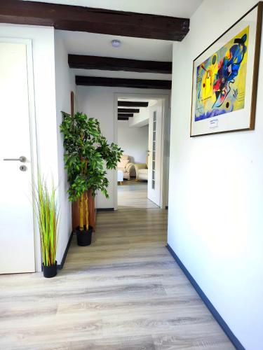a hallway with plants and a painting on the wall at Schwert City Loft S64 in Verden