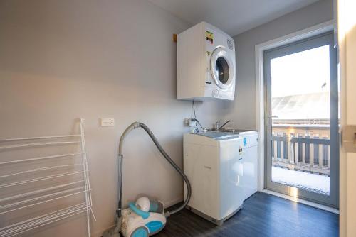 a kitchen with a refrigerator and a vacuum at Capricorn - 2BR Easy Drive to Dark Sky Dining in Lake Tekapo