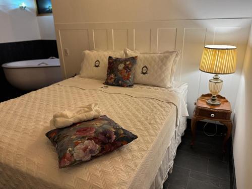 a bedroom with a bed with a pillow on it at Green Flowers Farm in Córrego do Bom Jesus