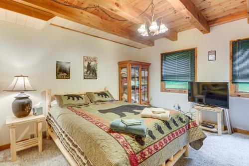 a bedroom with a bed and a flat screen tv at Pet-Friendly Cabin on 86 Acres in Scio Fish, Hike in Wellsville
