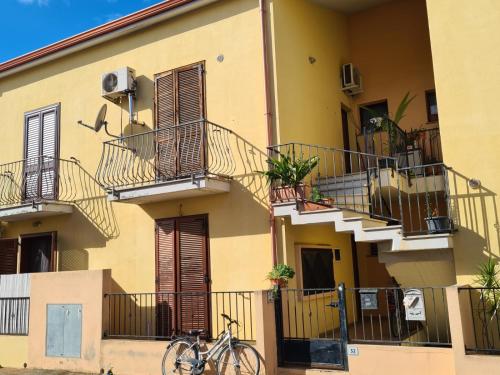a bike parked in front of a building with balconies at CasaGiuVaLeo in Pula