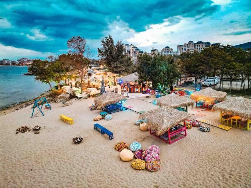 a beach with umbrellas and toys on the sand at Sorrento E 4 4 Sveti Vlas in Sveti Vlas