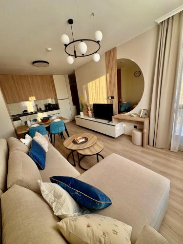 a living room with a couch and a table at Sorrento E 4 4 Sveti Vlas in Sveti Vlas