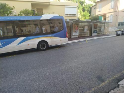 a blue and white bus parked on the side of a street at 3 minutes walking to monaco & the beach in Beausoleil
