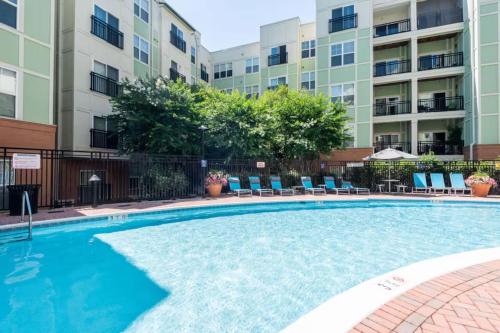 a swimming pool in front of a apartment building at The Manor - Alexandria in Alexandria