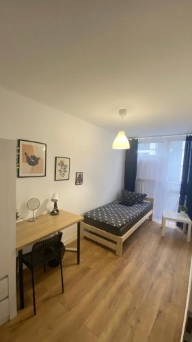 a room with a bed and a table in it at Warszawa Centrum Pokoje in Warsaw