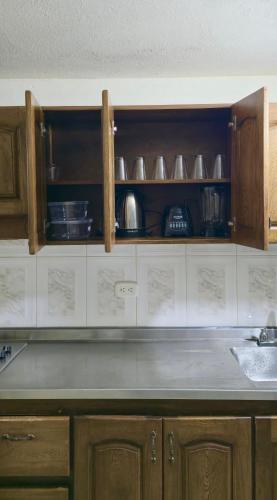 a kitchen with wooden cabinets and a counter top at Casa completa Comodidad-Ubicación Perfecta-CarmenV in Carmen de Viboral