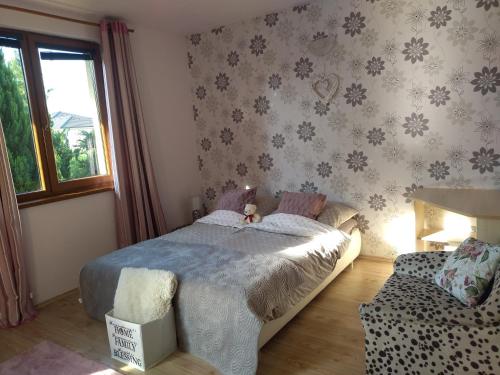 a bedroom with a bed and a couch at Villa Flower Deluxe II in Dunajská Streda