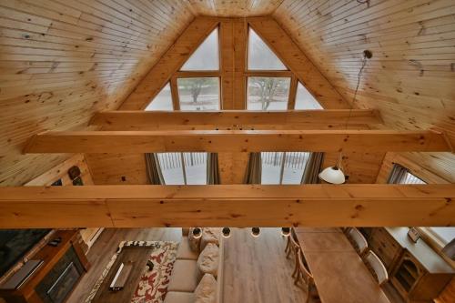 an attic view of a log cabin with a large window at NEW ! Lake front Lookout Log Cabin! Private Lake ! in Leonardsville