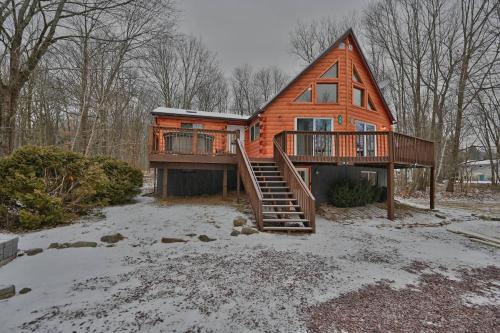 a wooden house with a staircase in the snow at NEW ! Lake front Lookout Log Cabin! Private Lake ! in Leonardsville