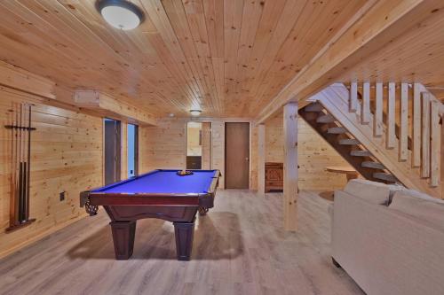 a pool table in a room with a staircase at NEW ! Lake front Lookout Log Cabin! Private Lake ! in Leonardsville