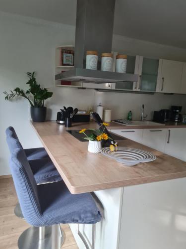 a kitchen with a wooden table with two chairs at DAS kleine Haus in Wandlitz