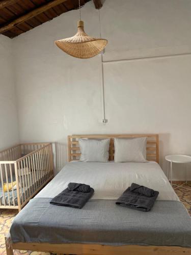 a bedroom with a bed with two towels on it at Santinho house 2 in Beja