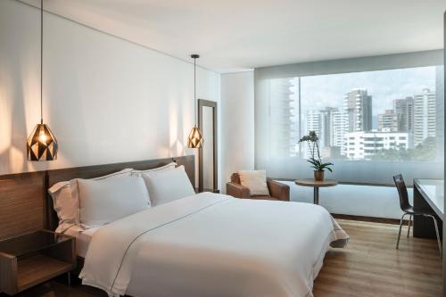 Ένα ή περισσότερα κρεβάτια σε δωμάτιο στο Hotel Poblado Alejandria