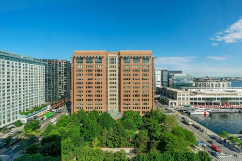 a tall building in a city next to a river at Renaissance Boston Seaport District in Boston