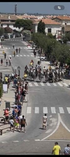 a group of people riding motorcycles on a city street at Entre ciel et bord de mer in Saintes-Maries-de-la-Mer