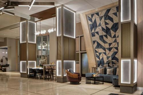 a lobby of a hotel with chairs and tables at Renaissance Dallas Hotel in Dallas