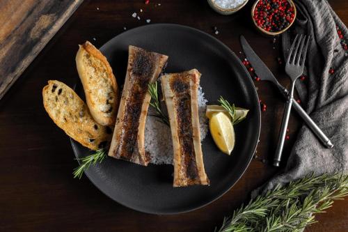 a black plate of food with bread and a lemon at Moon Palace The Grand Cancun All Inclusive in Cancún