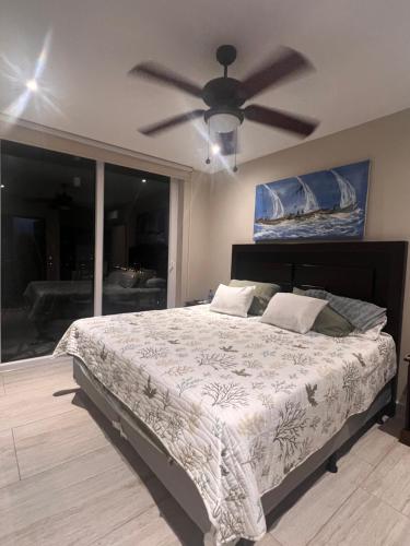 a bedroom with a bed with a ceiling fan at Tropical Views - Luxury Live #The Best Views #Walk to The Beach in San Juan del Sur