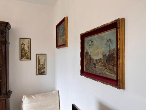 a painting on a wall with four pictures on it at Villa Relax&Fly near Malpensa with Pool in Sumirago