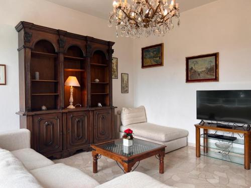 a living room with a couch and a tv at Villa Relax&Fly near Malpensa with Pool in Sumirago