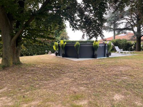a park with a table and chairs and a tree at Villa Relax&Fly near Malpensa with Pool in Sumirago