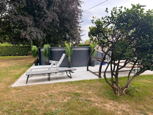 a bench and a tree in a yard at Villa Relax&Fly near Malpensa with Pool in Sumirago