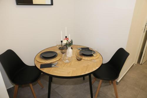 a dining room table with black chairs and a wooden table at Ok Apartments in Pforzheim