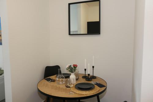 a dining room table with a mirror on the wall at Ok Apartments in Pforzheim