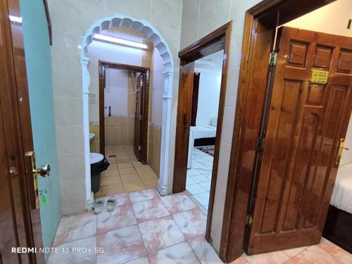 a hallway of a room with two doors and a bathroom at اجنحة الشام بلس in Al Madinah