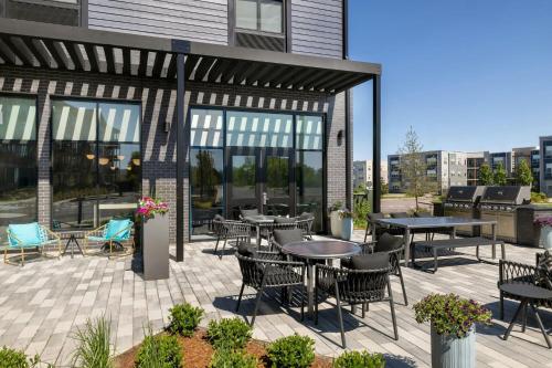 a patio with tables and chairs on a building at TownePlace Suites by Marriott Williston in Williston