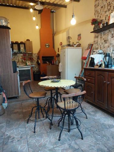 a kitchen with a table and chairs and a refrigerator at Flat Aconchego in Porto Velho