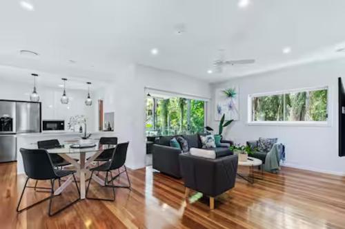 a kitchen and living room with a table and chairs at Park Ave Retreat - 3 Carparks, WiFi, BBQ, King Bed in Brisbane