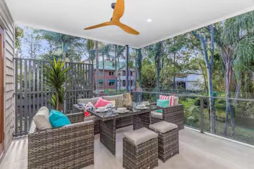 a patio with a table and chairs on a balcony at Park Ave Retreat - 3 Carparks, WiFi, BBQ, King Bed in Brisbane