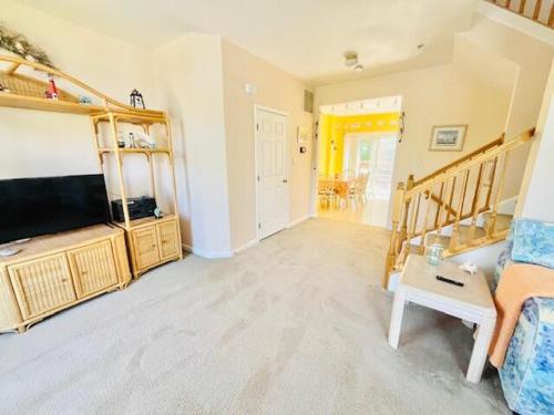 a living room with a couch and a television at Calvert street 14 in Ocean View