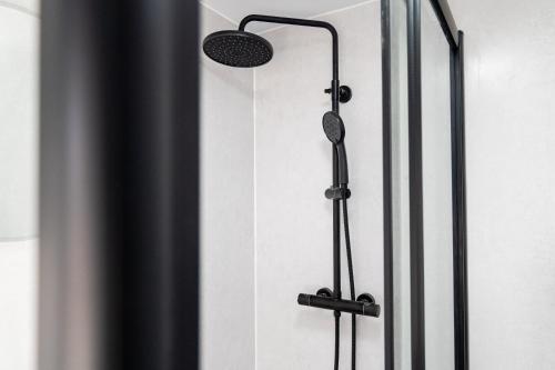 a shower in a bathroom with a shower head at 2 Bedroom House-Free Parking in Methil