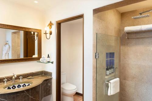 a bathroom with a shower and a sink and a toilet at Hacienda del Mar Los Cabos, an Autograph Collection All-Inclusive Resort in Cabo San Lucas