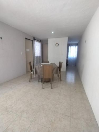 a dining room with a table and chairs at Casa 644 in Mérida