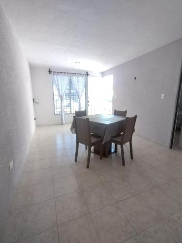 a dining room with a table and chairs at Casa 644 in Mérida