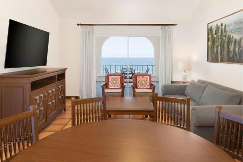 a living room with a table and a couch at Hacienda del Mar Los Cabos, an Autograph Collection All-Inclusive Resort in Cabo San Lucas