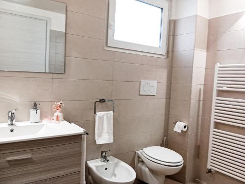 a bathroom with a sink and a toilet and a mirror at La Fontana in Montalbano