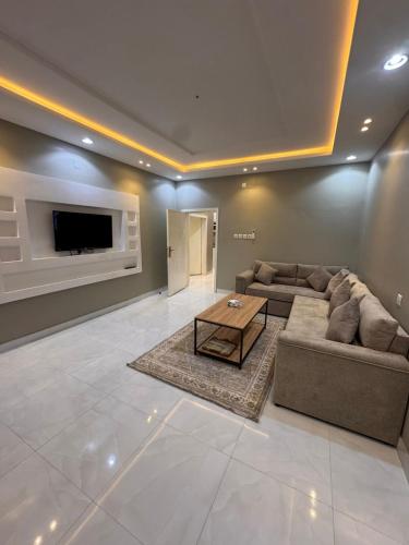 Телевизор и/или развлекательный центр в شقق وتين Wateen Apartments I
