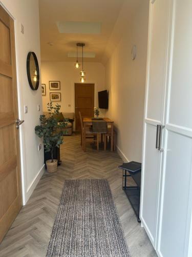 a hallway with a white refrigerator and a table at Collis Moor Annexe in Didcot