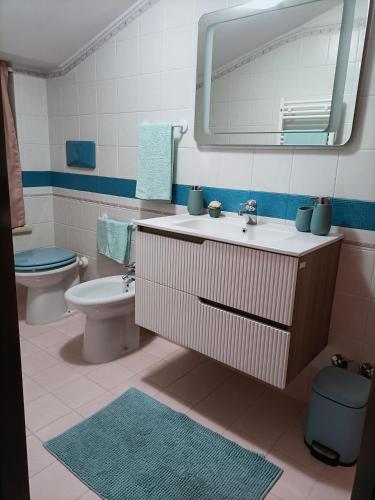 a bathroom with a sink and a toilet and a mirror at Comfort &Relax B&B&Spa in Villa Rosa