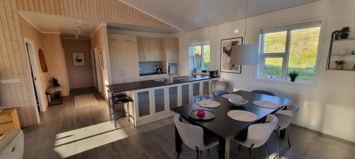 a kitchen and dining room with a table and chairs at Luxury Family Getaway in Selfoss