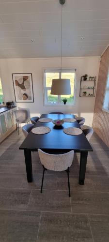 a dining room with a blue table and chairs at Luxury Family Getaway in Selfoss