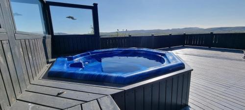 a blue tub sitting on top of a deck at Luxury Family Getaway in Selfoss